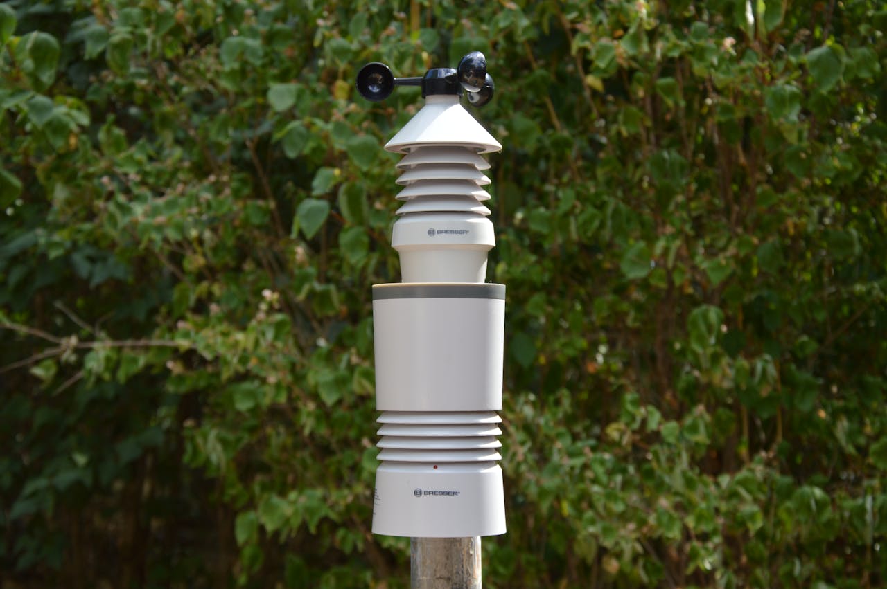 digital Close-up of a wireless weather station amidst green foliage, perfect for modern research and technology use.